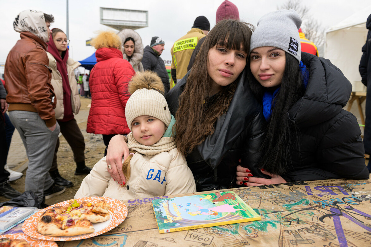 Angelika* (left), with her daughter Diana*, and cousin Natalya (right) outside a refugee reception centre near the Ukrainian border in Poland in March 2022. Image: Anthony Upton/DEC