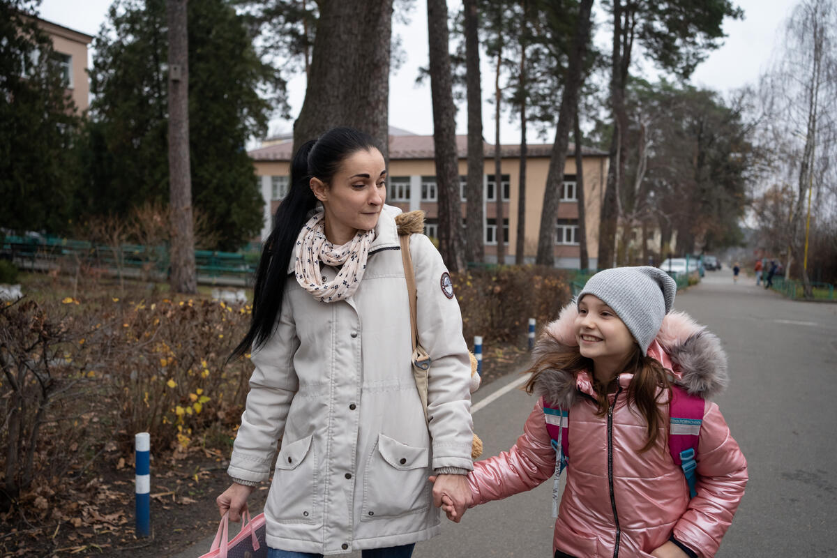 Oksana* and her daughter Khrystyna* in Kyiv in November 2022. The family have been supported with cash payments and vouchers from Save the Children. Image: Anastasia Vlasova/Save the Children