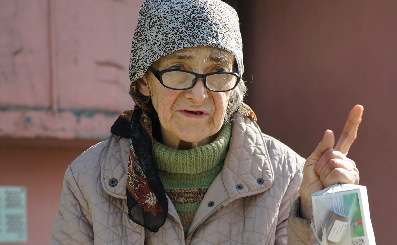 Nadia* outside her apartment block in Kharkiv after receiving food and medicines from a local partner of CAFOD in May 2022. Image: Dmytro Minyailo/DEC 