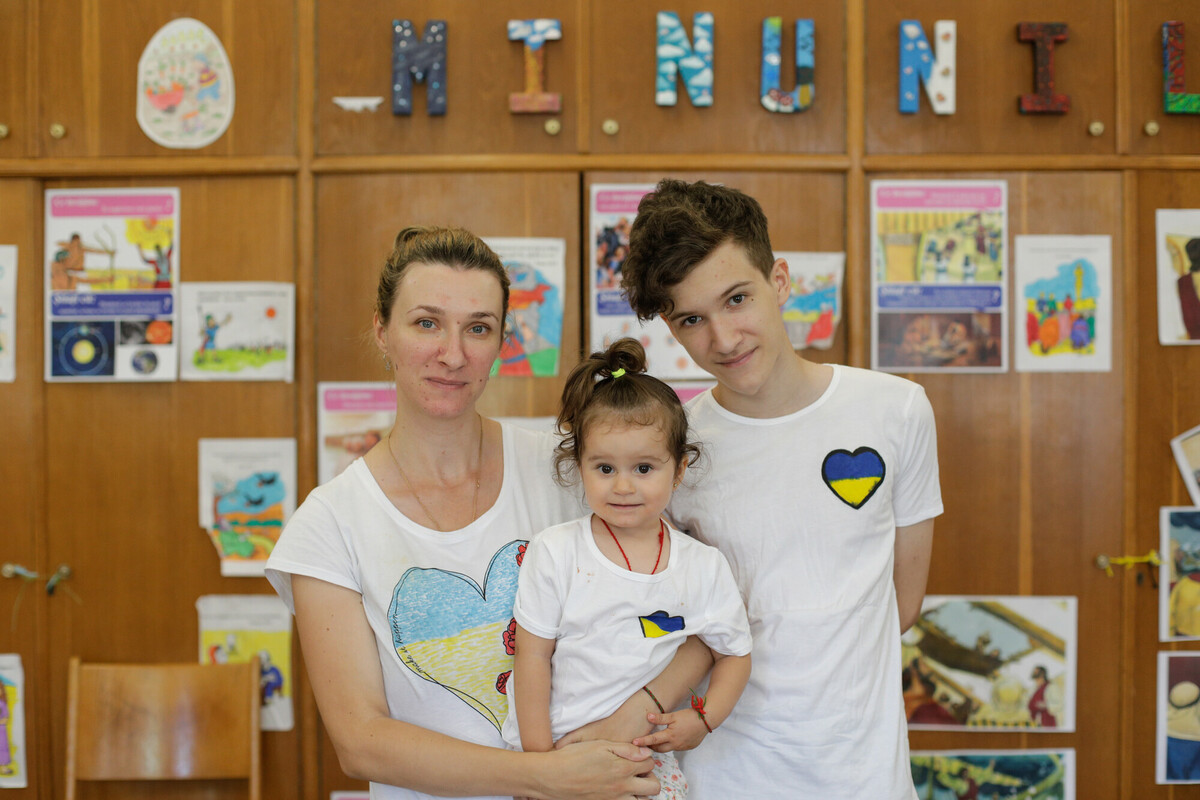 Viktoriia and her children in Bucharest, where they attend activities organised by ADRA, a partner of Plan International, and receive food vouchers with DEC funds. Image: George Calin/DEC.